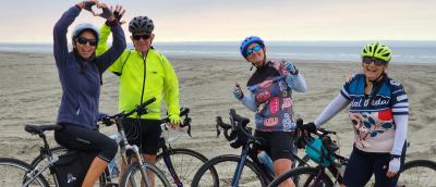 Happy riders posing on Long Beach during the Long Beach Tour Lite