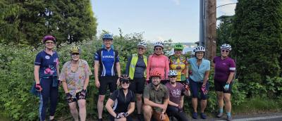 group posing in front of Lake Washington and Mount Rainier