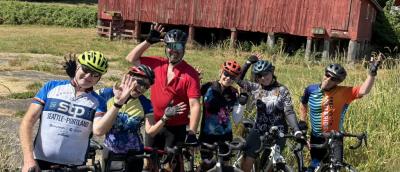 Goofy riders in front of red barn