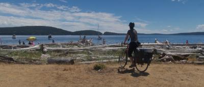 Photo by Earth Wandering, public via Flickr. Person bike touring on the San Juan Islands in 2018.