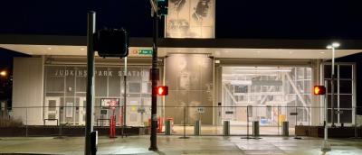 Night view of the Judkins Park light rail station with black and white photographs of Jimi Hendrix on the facade
