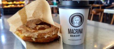 A cinnamon roll and a coffee on the counter at Macrina Bakerry on Queen Anne