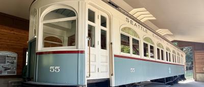 a historic trolley car for the Seattle Everett Interurban Railway sits on display inside a sheltered garage