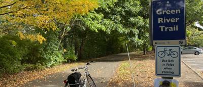 Bike on the Green River Trail with yellow leaves on the ground.