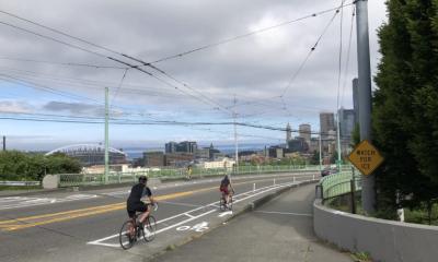 Cyclists riding over the Jose Rizal Bridge's new protected bike lanes