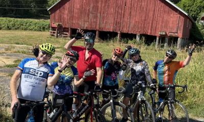 Goofy riders in front of red barn