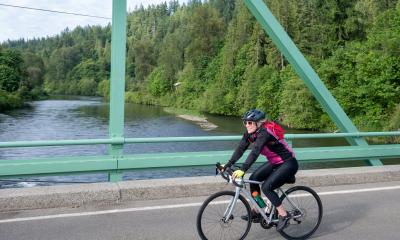 A woman rides across the bridge on Flying Wheels in 2025