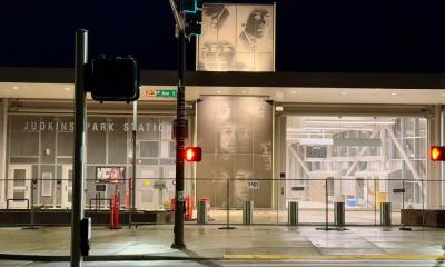 Night view of the Judkins Park light rail station with black and white photographs of Jimi Hendrix on the facade