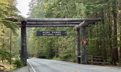 A photo of the gateway entrance to Mount Rainier National Park in the forest. 