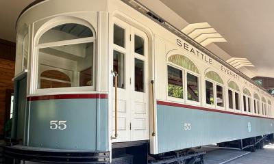 a historic trolley car for the Seattle Everett Interurban Railway sits on display inside a sheltered garage