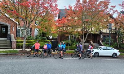 Cyclists with fall trees