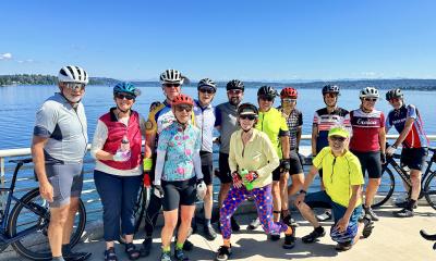 group of cyclists by the water