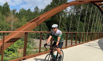 Tom Butler rides the Whiter River Bridge on the Foothills Trail