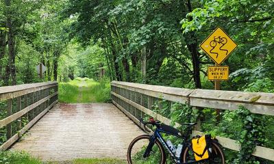 Bike on gravel near bridge