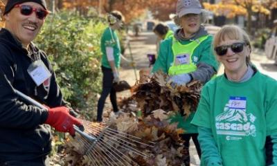 Volunteers clear leaves from a bike lane in Seattle.