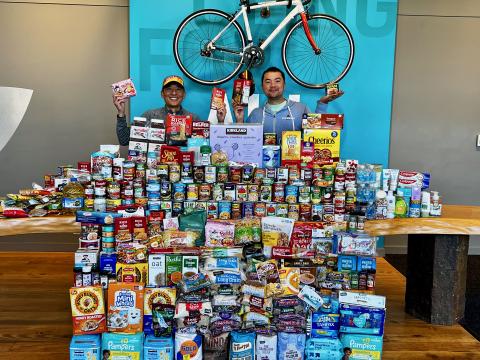 Stacks of canned goods with staff