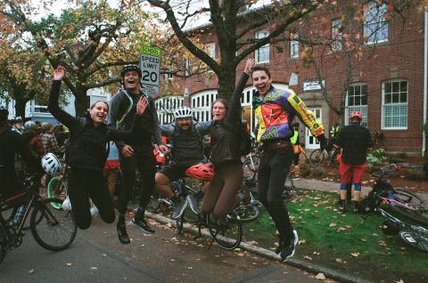 Cranksgiving participants leaping in the air